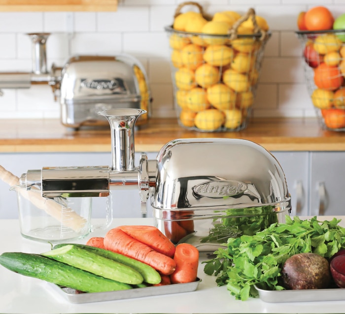 Angel Juicer with vegetables, on a kitchen surface. Angel Juicer with vegetables, on a kitchen surface.