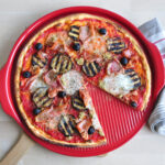 Emile Henry Pizza Stone Ridged with Pizza