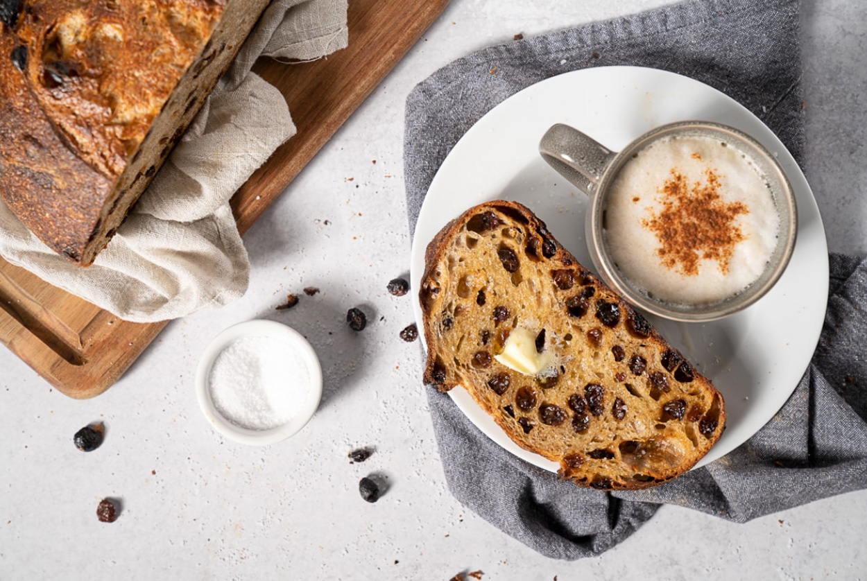 A Sourdough Loaf with raisins - sliced and buttered