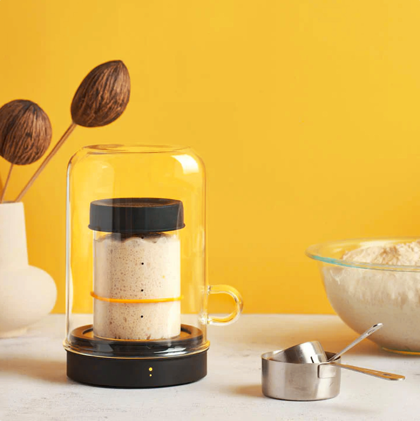 The Goldie Sourdough Warmer in a lifestyle setting with a yellow background